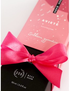 Wrapping the product with a bright pink ribbon + scent spraying